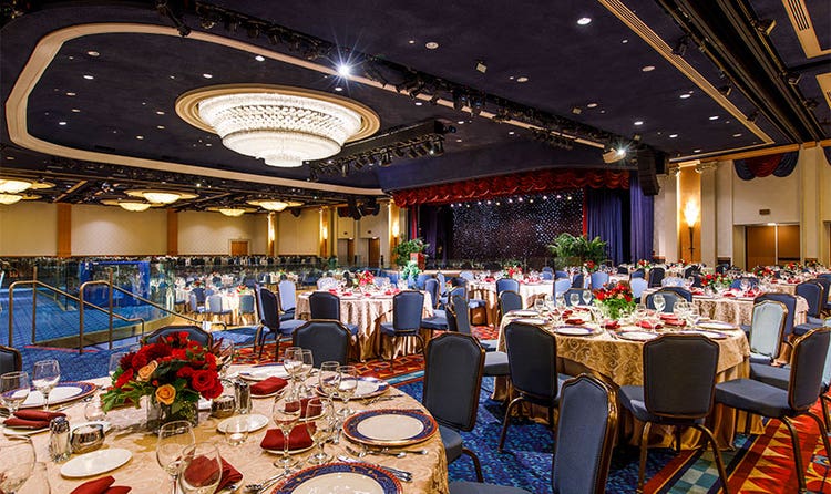 A Disneyland Hotel ballroom featuring tables and chairs in front of a dance floor