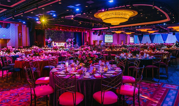 A Disneyland Hotel ballroom featuring tables and chairs in front of a dance floor