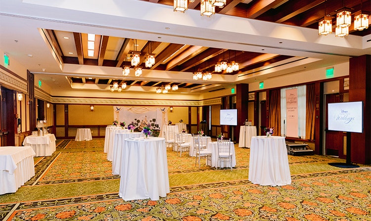 Hight tables with flower decorations set up in a venue at Disney’s Grand Californian Hotel and Spa