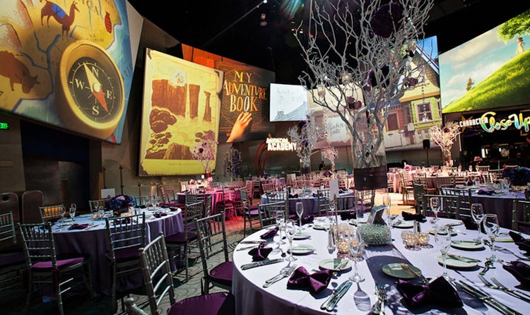 Round tables arranged in a room with large pictures showing scenes from 'Up'