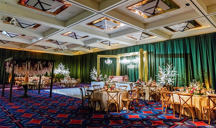 A large room with several round tables and light fixtures shaped like trees