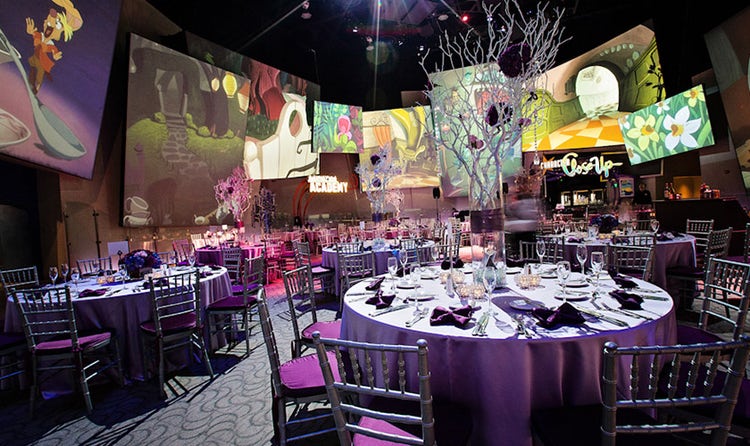 Tree branches extend up from centerpieces on round tables