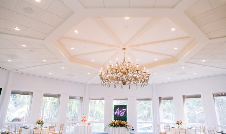 An event room featuring a grass wall panel with a sign that says, ‘A and J’