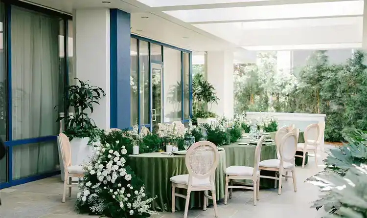An outdoor wedding reception area with tables and chairs
