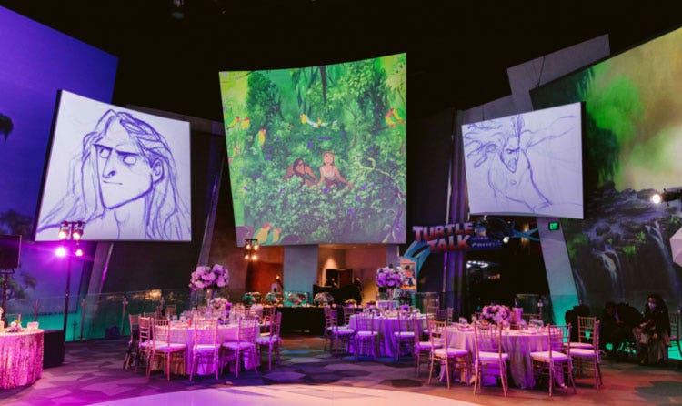 An event room in the Disney Animation Building with projection panels featuring artwork from Tarzan