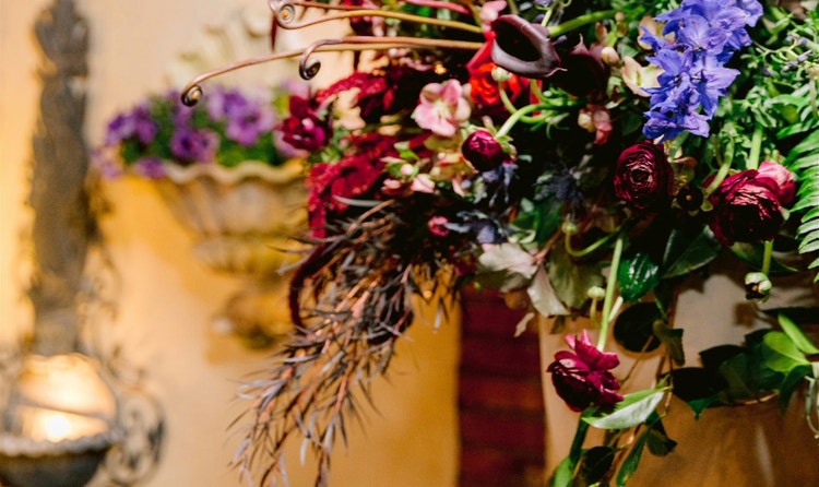 A floral arrangement near a fountain at the Magnolia Park Terrace wedding venue