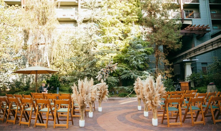 Chairs lined with plumes of pampas along an aisle at Disney’s Grand Californian Hotel and Spa