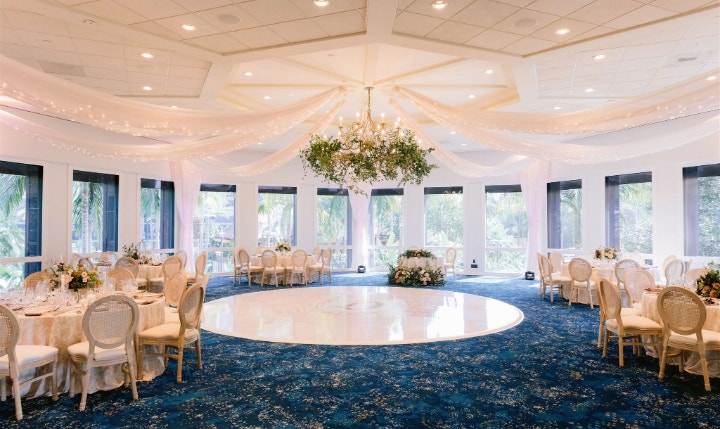 An event room featuring a grass wall panel with a sign that says, ‘A and J’