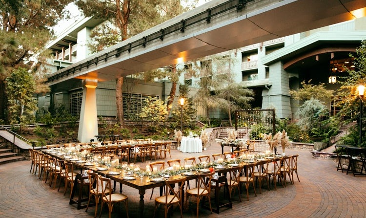 Long tables in a courtyard beneath monorail tracks at Disney’s Grand Californian Hotel and Spa