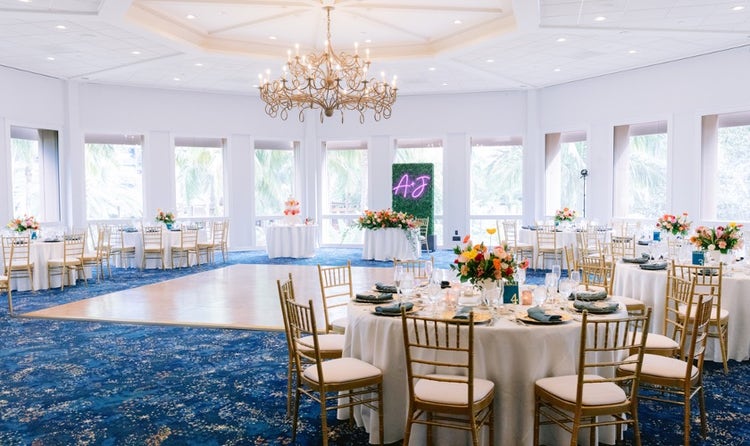 An event room featuring a grass wall panel with a sign that says, ‘A and J’