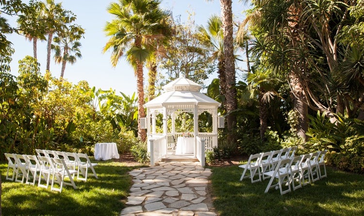 Chairs lined up on a lawn facing a gazebo at Disneyland Hotel