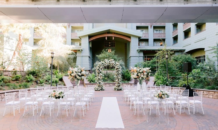 Chairs along an aisle leading to a flower arch in Disney’s Grand Californian Hotel and Spa