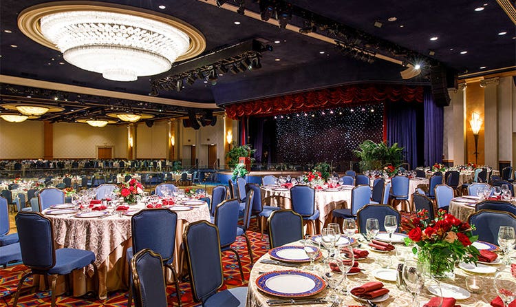 A Disneyland Hotel ballroom featuring tables and chairs in front of a dance floor
