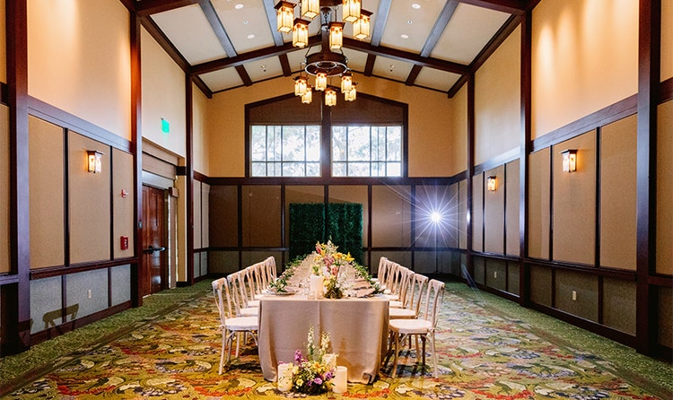 A room featuring a dining table with flower decorations in a venue at Disney’s Grand Californian Hotel and Spa