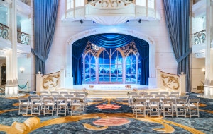 An artist rendering of the multi level Atrium aboard the Disney Destiny features a curved staircase next to a statue of the Black Panther