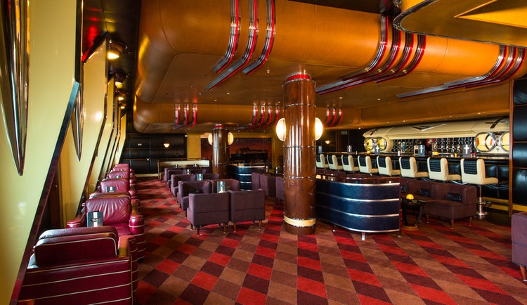 A car-themed lounge has décor modeled after the trim and detailing on classic Cadillac cars