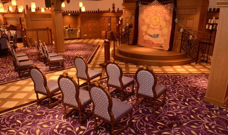 Chairs and a podium set up for a wedding ceremony at Rapunzel’s Royal Table on the Disney Magic