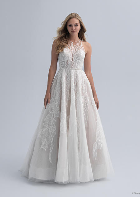 A bride in a wedding dress with an illusion neckline with crystal adornment and a defined waist
