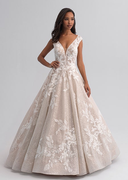 A woman wearing a sleeveless wedding gown covered with a shimmery lace