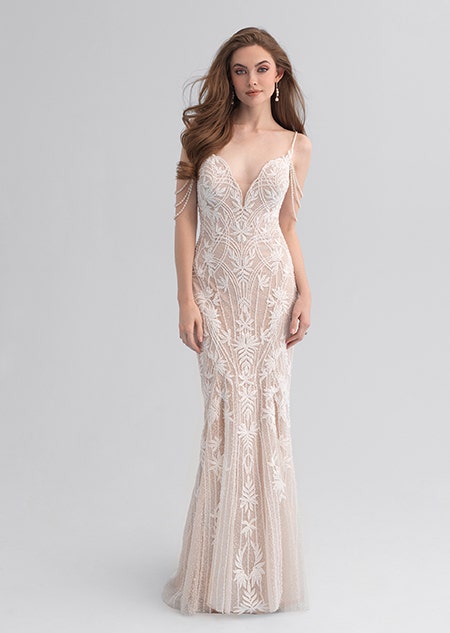 A woman wearing a form fitting wedding dress covered with lacy patterns