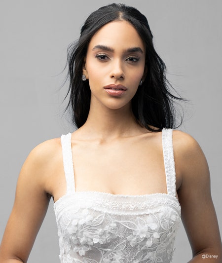 The bodice of a bride wearing a Snow White inspired ball gown featuring lace detail and a square neckline