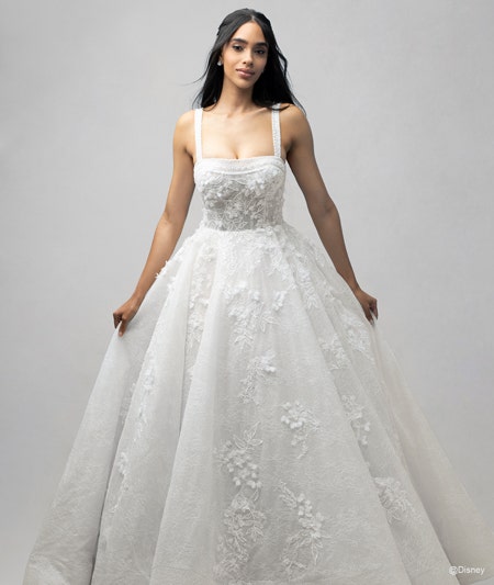 The front of a bride wearing a Snow White inspired ball gown featuring lace detail and a square neckline