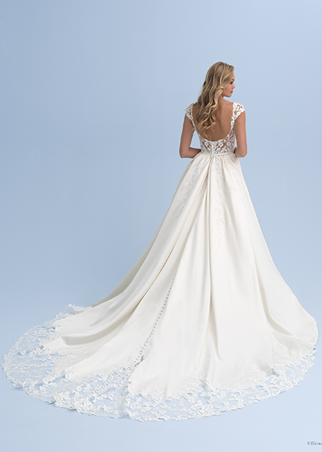 The back view of a bride wearing a wedding dress with cap sleeves and lace at the end of the train