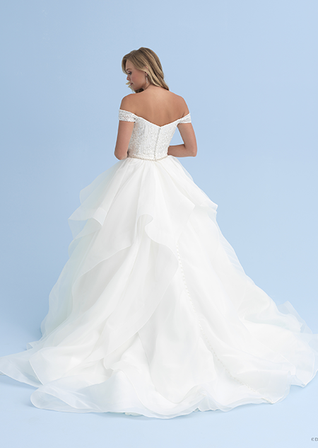 The back of a woman in an off the shoulder dress with a skinny belted waist and a full skirt