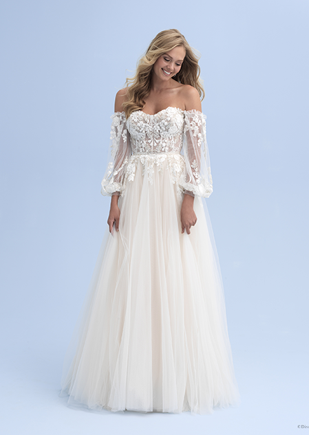 A bride wearing an off the shoulder wedding dress with see thru sleeves