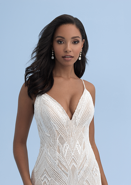 A close up of a wedding dress with a sweetheart neckline and skinny straps