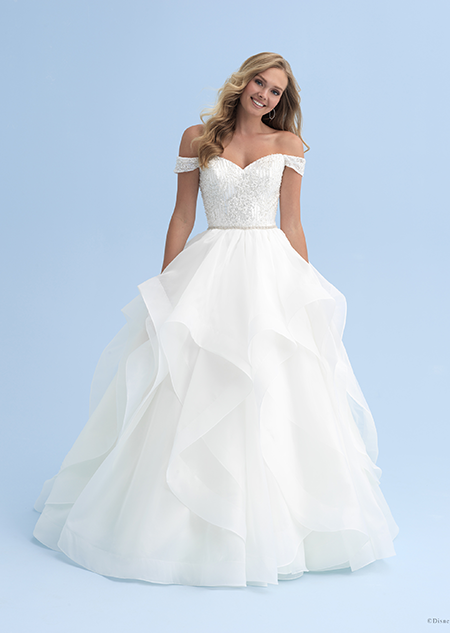 A woman in an off the shoulder dress with a skinny belted waist and a full skirt