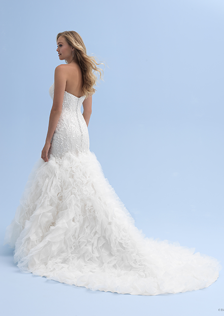 A side view of a woman in a wedding dress with a ruffled skirt