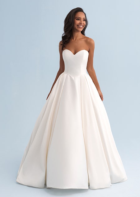 A woman wearing a strapless wedding dress with a full skirt