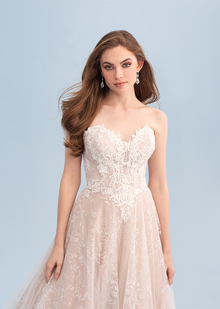 A woman wearing a strapless and lacy wedding dress