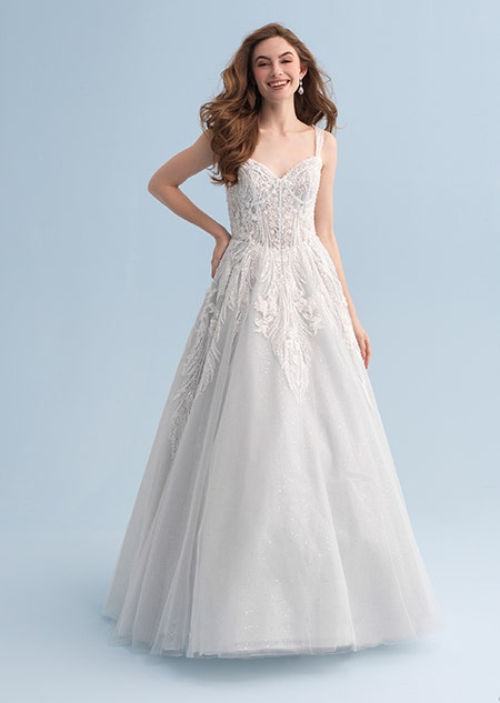 A woman wearing a full length wedding dress with a lacy bodice