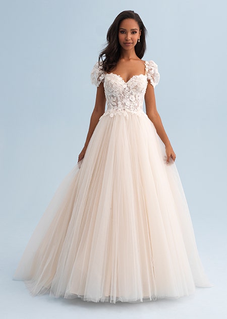 A woman in a wedding dress with puffy sleeves and a lacy bodice