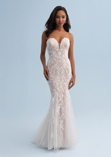 A woman wearing a form fitting and strapless wedding dress covered with lace