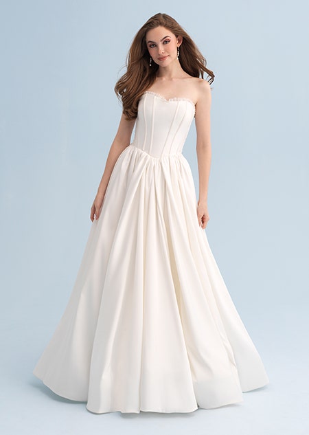 A woman wearing a strapless wedding dress with a full skirt