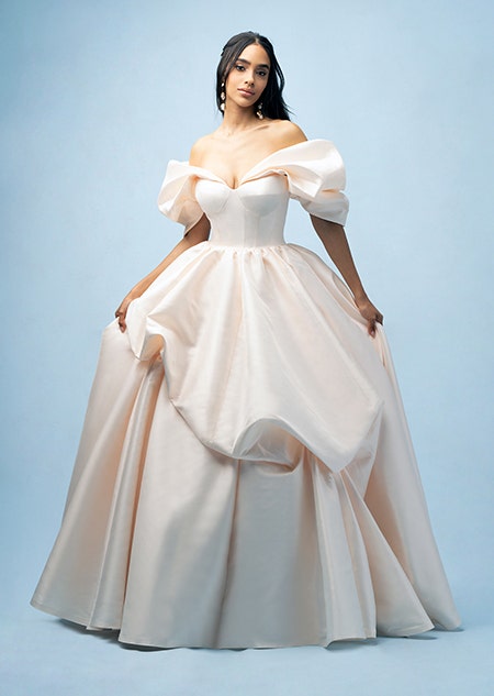 The front of a bride wearing a Belle inspired ball gown featuring an off the shoulder neckline