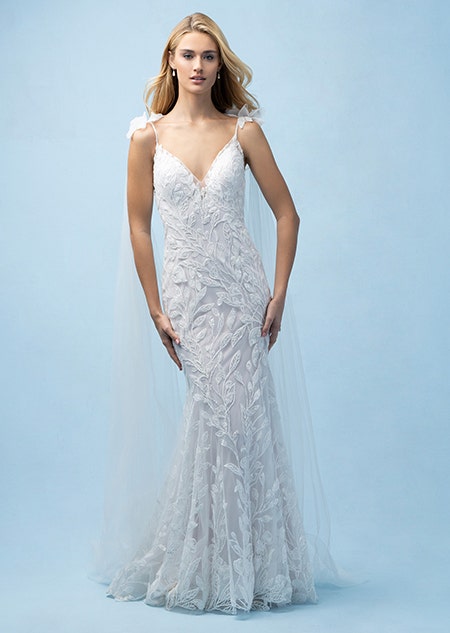 The front of a bride wearing a Rapunzel inspired sheath gown featuring a V neckline and lace detail