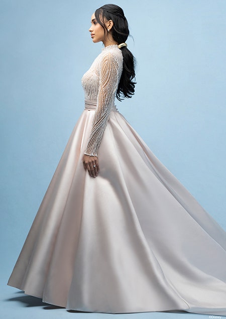 The side of a bride wearing a Jasmine inspired ball gown featuring an illusion neckline, a sheer beaded bodice and long sleeves