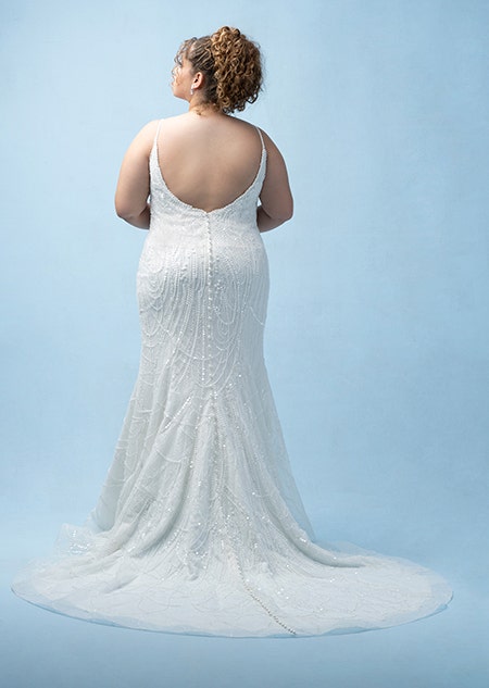 The back of a bride wearing a Tiana inspired sheath gown featuring beading, sequins, a train and spaghetti straps