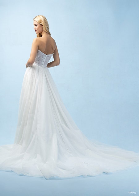 The back of a bride wearing an Ariel inspired A line gown featuring lightly beaded fabric and a train