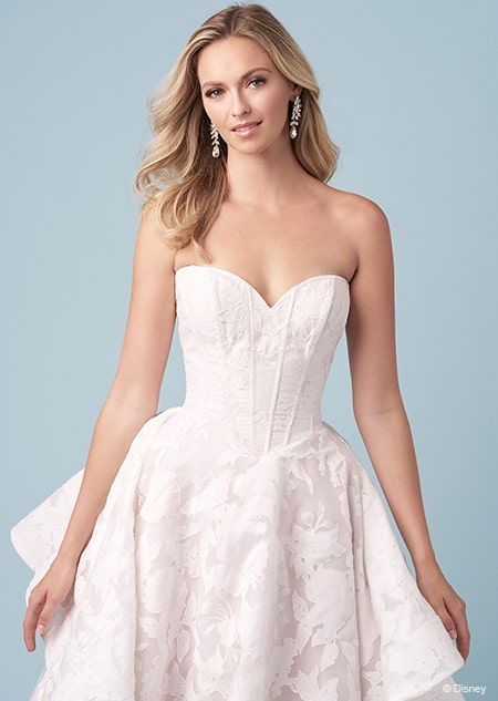 A bride wearing a strapless Rapunzel themed ball gown featuring a sweetheart neckline