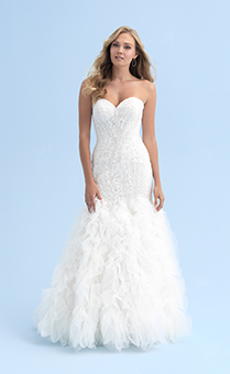 A woman in a form fitting wedding dress with a ruffled skirt