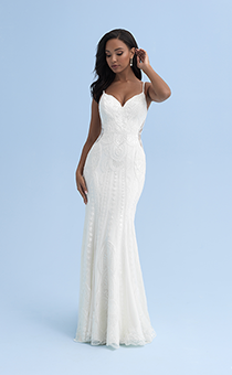 A woman in a form fitting wedding dress with skinny straps and cutouts on the sides