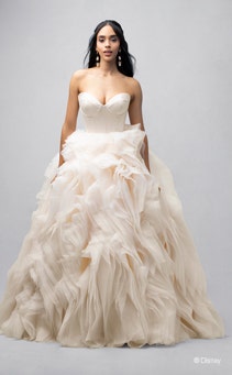 A bride wearing a Belle inspired ball gown with a sweetheart neckline and a ruffled skirt