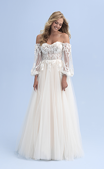 A bride wearing an off the shoulder wedding dress with see thru sleeves