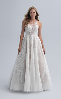 A bride in a wedding dress with an illusion neckline with crystal adornment and a defined waist