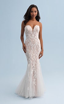 A woman wearing a form fitting and strapless wedding dress covered with lace